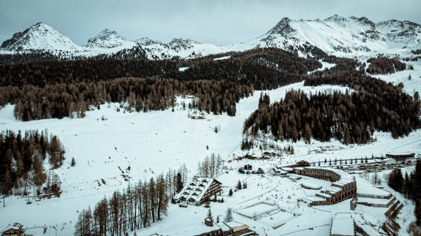 aerial view of village near ski slopes in day light Drone shot of village near ski slopes in day light from high point of view with cloudy sky pila stock pictures, royalty-free photos & images