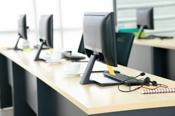 istock Chairs computers and headset call center in modern office 1211812005