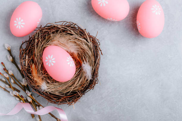 istock Colorful Easter egg in the nest on gray stone concrete background 1211812228