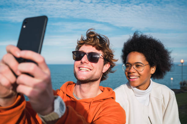 istock Two friends taking a selfie with smartpone. 1211812338