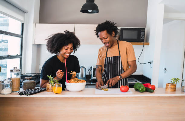 istock Afro couple cooking together in the kitchen. 1211812893
