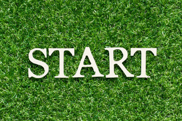 istock Wood alphabet letter in word start on artificial green grass background 1211812983
