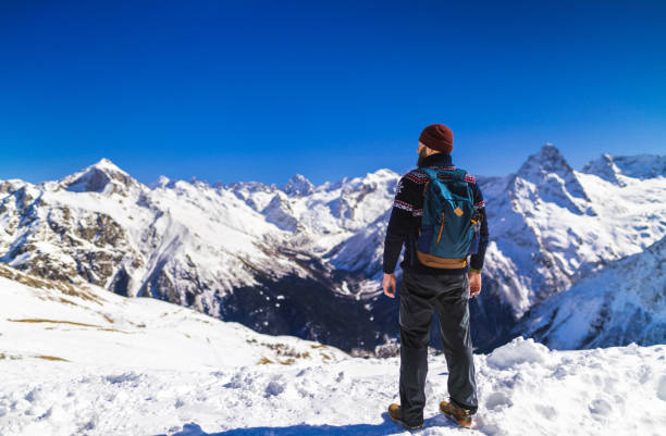 istock Tourist exploring snowy mountains 1211813077