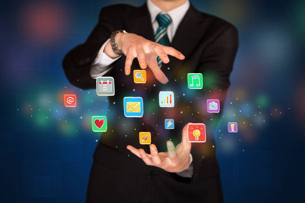 istock Businessman holding application icons 1211814803