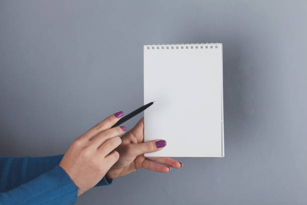 istock woman hand pen and notepad 1211816247