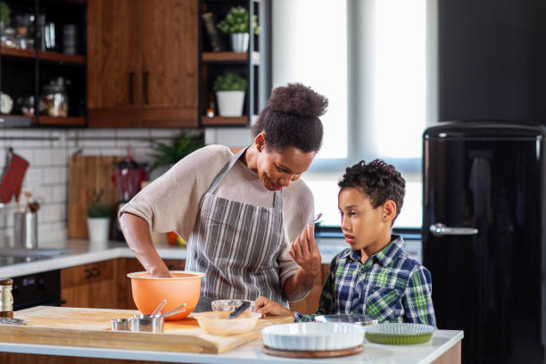 istock Mother with his son prepare pie in the kitchen 1211816571