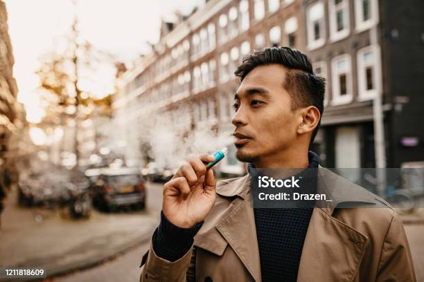 Japanese Man Vaping In The Street Stock Photo - Download Image Now - Electronic Cigarette, Men, People