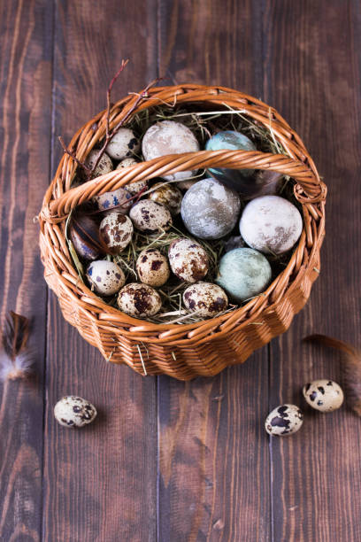 Close up of colorful Easter eggs in a basket. Easter composition
