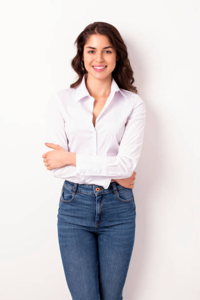 istock Attracive young woman looking at camera and laughing while standing at isolated white background 1211823219