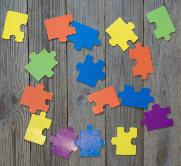 istock colored puzzle on wooden boards team business concept 1211824863