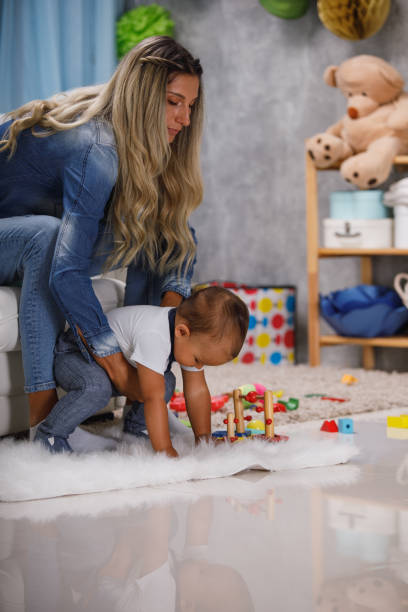 istock Mother playing with her little baby son 1211825158