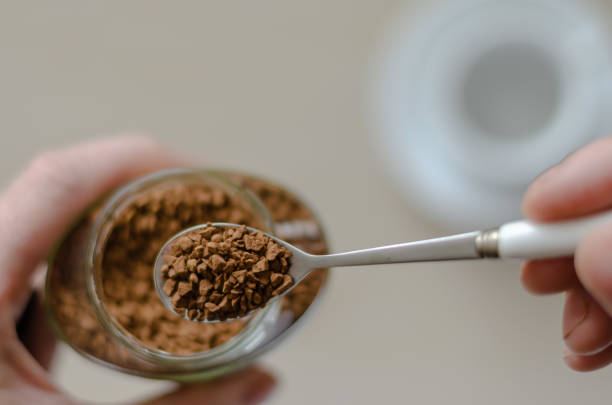 istock Glass jar with coffee in a hand 1211825357