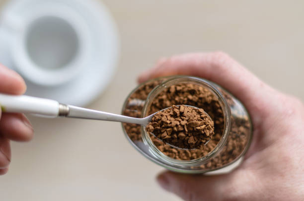 istock Glass jar with coffee in a hand. 1211825415