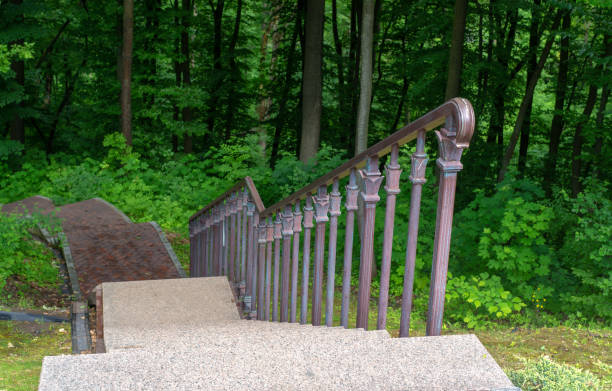 istock Stairways with stone railings balusters and iron lanterns, landscape design walking path for walking, green lawns and a variety of bushes 1211826031