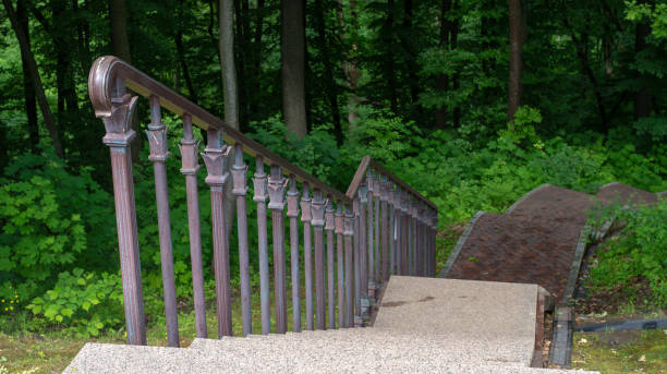 istock Stairways with stone railings balusters and iron lanterns, landscape design walking path for walking, green lawns and a variety of bushes 1211826096
