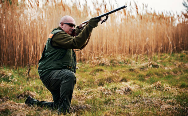 istock Hunter with a rifle in hunting 1211826221