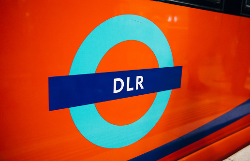 LONDON, UK - FEBRUARY 20, 2020: DLR sign on the side of train car.