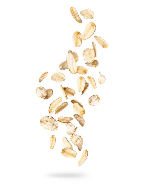 Photo of Oat flakes frozen in the air, isolated on white background