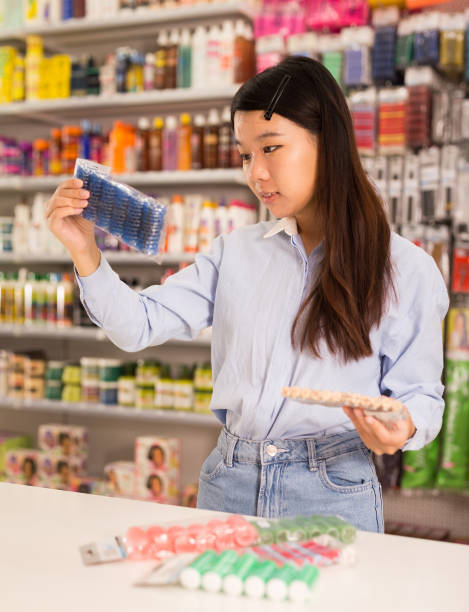 istock Woman choosing plastic hair curlers 1211829645