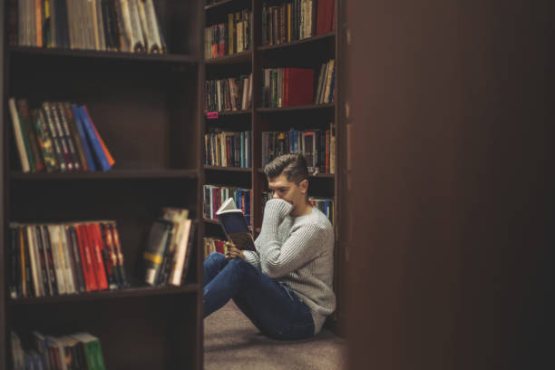 istock Student in the library searches for literature 1211829751