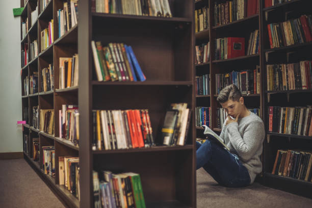 istock Student in the library searches for literature 1211829758