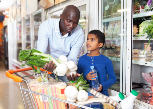 istock man with son choosing fresh greens and vegetables 1211831085