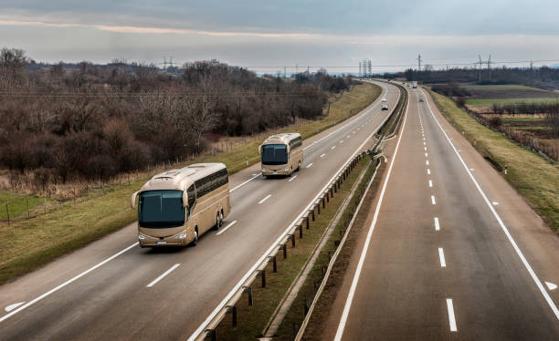 istock Two buses in line traveling on a highway 1211831407