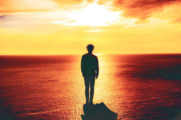 istock man standing in front of an apocalyptic landscape 1211834497