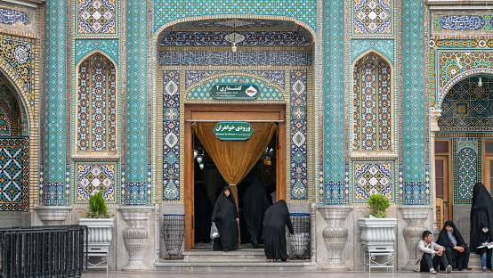 Shrine of Fatima Masumeh, Qom, Iran - May 2019: Iranian women walking inside Shrine of Fatima Masumeh in Qom, which is considered by Shia Muslims to be the second most sacred city in Iran.
