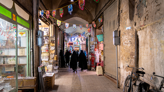 Isfahan, Iran - May 2019: Grand bazaar of Isfahan, also known as Bazar Bozorg with tourists and local people shopping, historical market