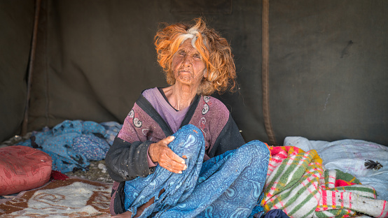 Shiraz, Iran - May 2019: Old Qashqai Turkish nomadic woman inside her tent. The Qasqhai are nomadic people living in temporary villages.