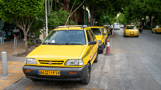 Isfahan, Iran - May 2019: Yellow taxi car on the street