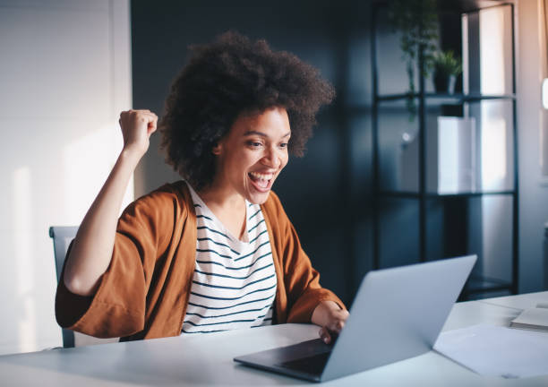 istock Young female entrepreneur browsing on laptop in the office. 1211837113
