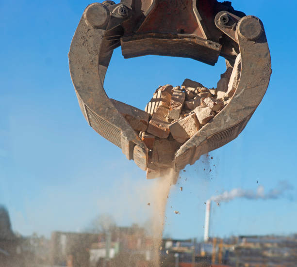 istock Lifting bricks and other debris at building site 1211838022