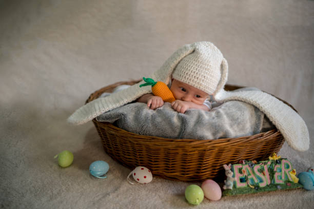 istock baby Easter bunny in basket with eggs 1211838226