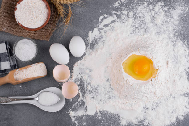 istock Top view eggs, dough, flour, salt and sugar on grey background 1211842432