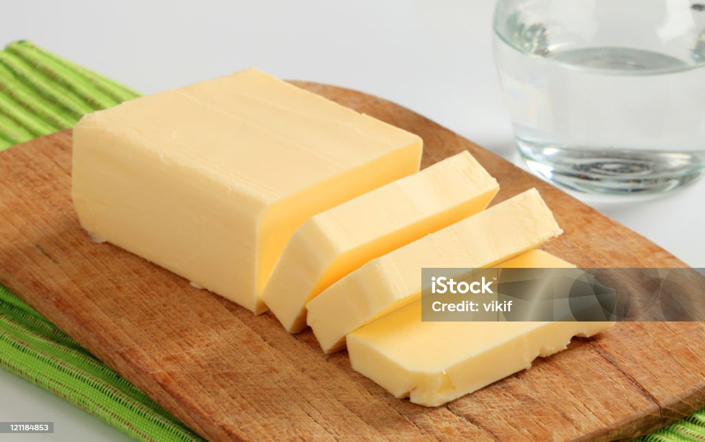 Fresh butter Block of fresh butter  on a cutting board Block Shape Stock Photo