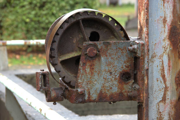 istock Gear wheel, roller on a rusted steel beam 1211848655