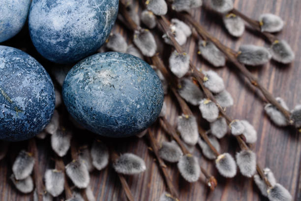 istock Blue Easter eggs and bouquet of willow flowers on rustic table wood. Naturally Eggs painted with hibiscus with marble stone effect . 1211848853