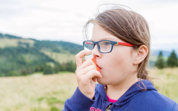 istock Girl having asthma using asthma inhaler for being healthy 1211848950