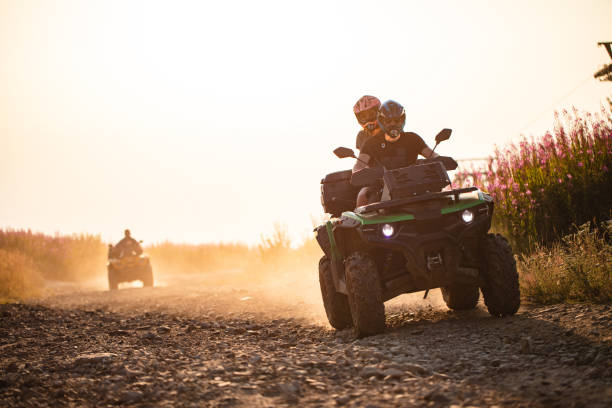 Just us and the road Sporty boyfriend and girlfriend on a mountain riding around on a quad bike quadbike photos stock pictures, royalty-free photos & images