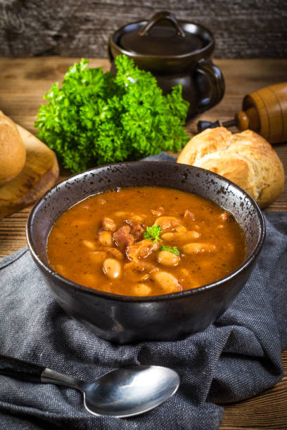 istock Beans with tomato sauce, bacon and sausage. 1211851158