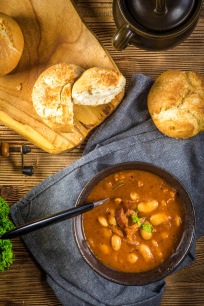 istock Beans with tomato sauce, bacon and sausage. 1211851192