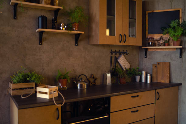 istock Close-up of interior design kitchen. Modern domestic dark interior of kitchen cabinets and shelves with cookware 1211856463