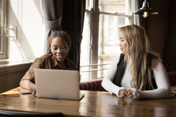 istock Young women working on laptop in cafe 1211856979
