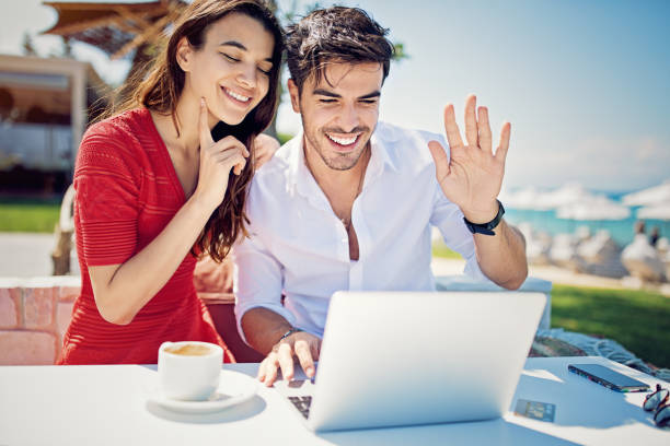 istock Couple is hugging and making video call on the beach 1211857572