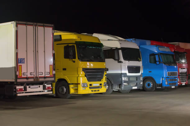 istock Trucks semi-trailers in the parking lot at night 1211857647
