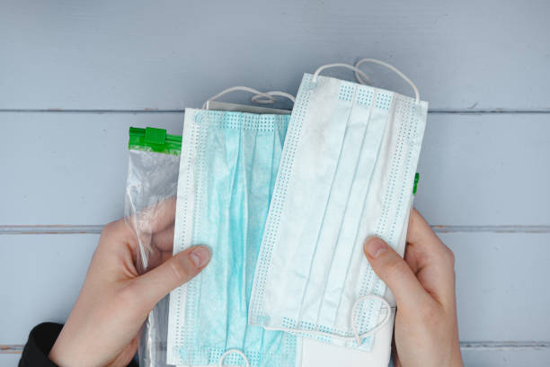 istock Respiratory masks in a package in human hands. 1211858971