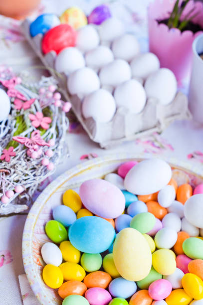 istock Bright colored eggs, large and small for Easter Sunday. Traditional treats. Copy space. Vertical photo. 1211860127
