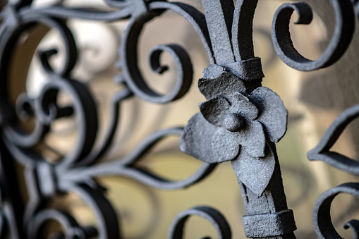 Vintage forged metal pattern. Decorative elements of a gate, porch as a background.